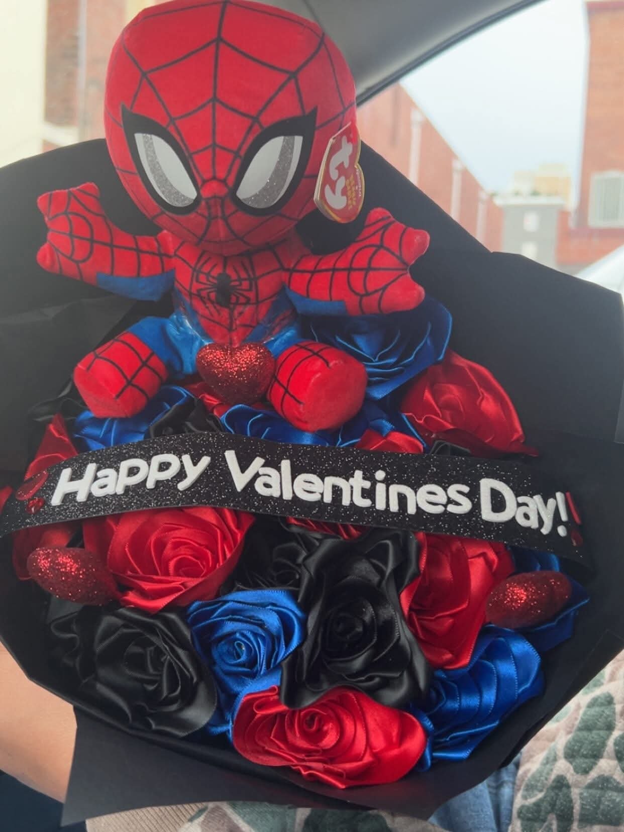 Red, blue and black ribbon rose bouquet with a Spider-Man plush and Happy Valentines Day ribbon